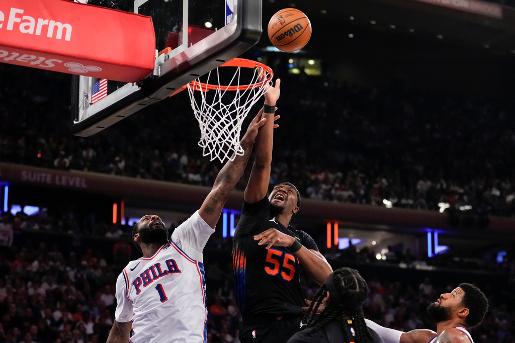 New York Knicks center Ariel Hukporti (55) fights for control of the ball with Philadelphia 76ers center Andre Drummond (1) during the first half of Game 2 in a second-round NBA basketball playoffs series, Wednesday, May 6, 2026, in New York. (AP Photo/Yuki Iwamura)