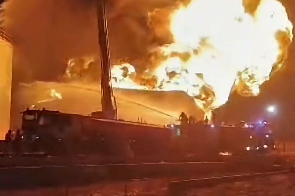This frame grab from video shows firefighters working to contain a fire at the Zawiya oil refinery following a drone strike in Zawiya, Libya, Tuesday, Aug. 11, 2026. (Libyan Fire Department via AP)
