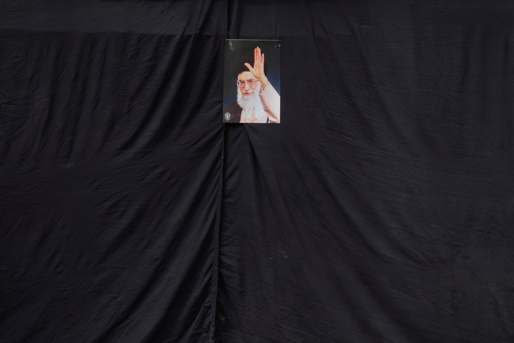 A picture of the late Iranian Supreme Leader Ayatollah Ali Khamenei hangs on a black sheet along the side of a mosque in Tehran, Iran, Monday, March 2, 2026. (AP Photo/Vahid Salemi)