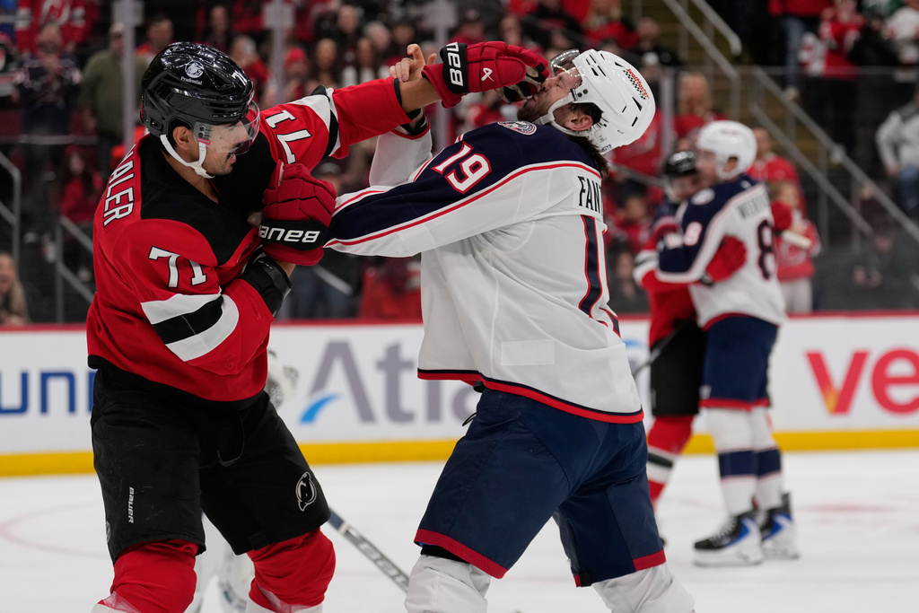 New Jersey Devils' Jonas Siegenthaler, left, and Columbus Blue Jackets' Adam Fantilli fight during the second period of an NHL hockey game in Newark, N.J., Monday, Dec. 1, 2025. (AP Photo/Seth Wenig)