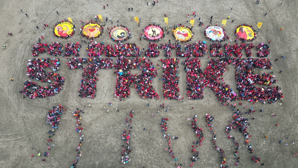 Hundreds of San Francisco teachers form a human banner spelling "STRIKE" on Ocean Beach on the third day of a district-wide strike over wages, benefits and other issues, Wednesday, Feb. 11, 2026. (AP Photo/Terry Chea)
