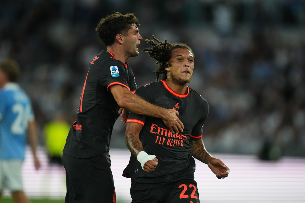 AC Milan's Diego Moreira, right, celebrates after he scored his side's second goal with his teammate Christian Pulisic during a Serie A soccer match between Lazio and AC Milan, in Rome, Saturday, Sept. 12, 2026. (AP Photo/Alessandra Tarantino)