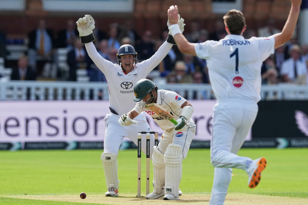 Pakistan's Mohammad Rizwan is out lbw on the bowling of England's Ollie Robinson, right, on day two of the second cricket test match between England and Pakistan in London, Friday, Aug. 28, 2026. (AP Photo/Dave Shopland)