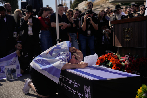 Naomi Baruch grieves over the coffin of her son, Uriel Baruch, a slain hostage whose body was returned from Gaza as part of a ceasefire agreement between Israel and Hamas, in Jerusalem, Sunday, Oct. 19, 2025. (AP Photo/Ohad Zwigenberg) Naomi Baruch grieves over the coffin of her son, Uriel Baruch, a slain hostage whose body was returned from Gaza as part of a ceasefire agreement between Israel and Hamas, in Jerusalem, Sunday, Oct. 19, 2025. (AP Photo/Ohad Zwigenberg)