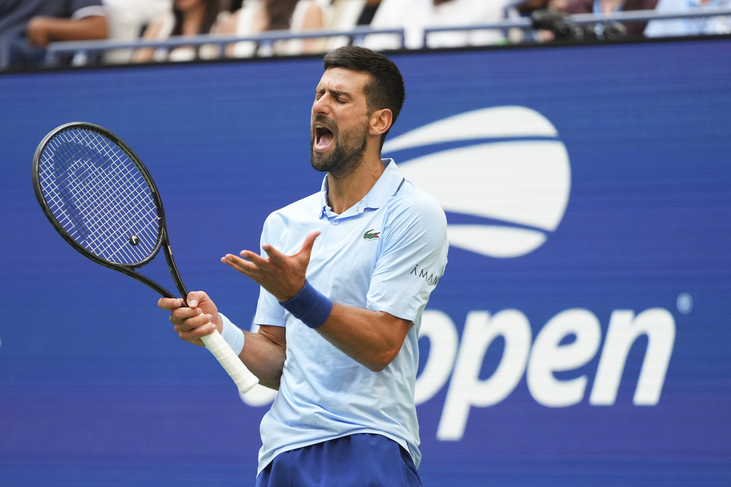 Novak Djokovic, of Serbia, reacts after a rally against Carlos Alcaraz, of Spain, during the men's singles semifinals of the U.S. Open tennis championships, Friday, Sept. 5, 2025, in New York. (AP Photo/Kirsty Wigglesworth)