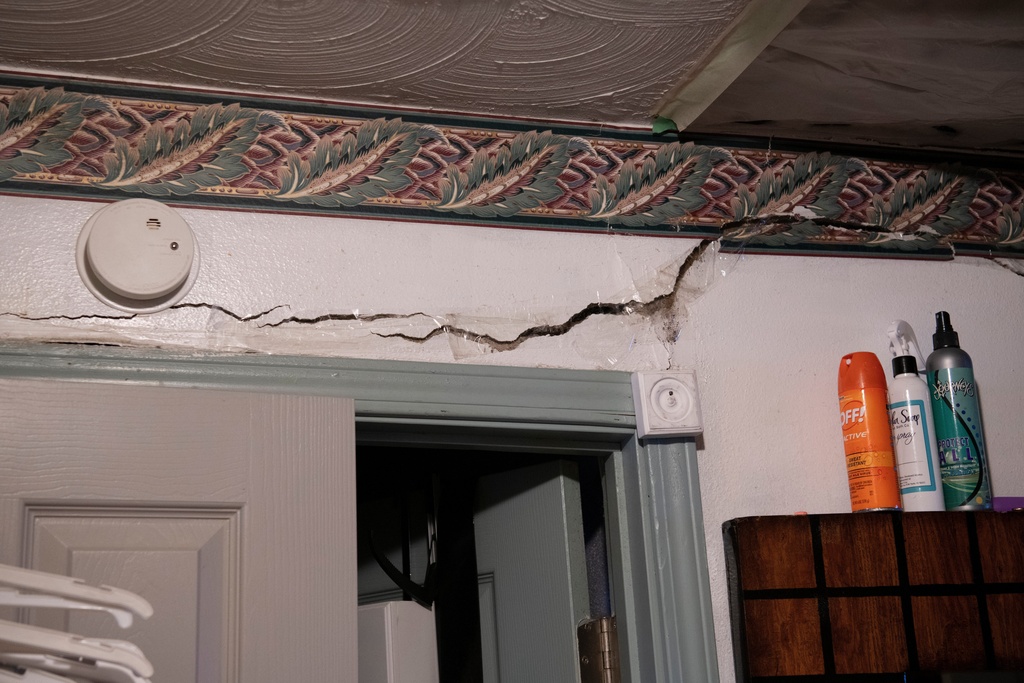A crack is visible on the wall of Yvette Lyles' home where she says flooding has caused significant damage in Cahokia Heights, Ill., May 15, 2025. (AP Photo/Michael Phillis)