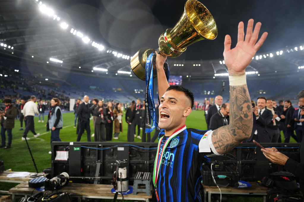 Inter Milan's team captain Lautaro Martinez shows the trophy to the supporters after defeating Lazio to win the Italian Cup soccer final in Rome, Wednesday, May 13, 2026. (AP Photo/Andrew Medichini)