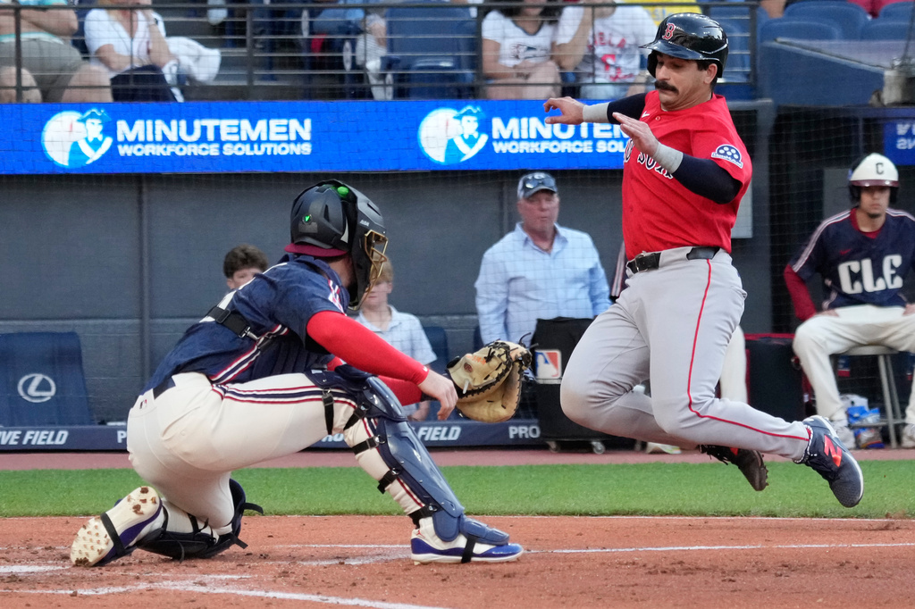 Boston Red Sox' Mickey Gasper, right, begins his slide as Cleveland Guardians catcher Patrick Bailey, left, waits with the ball to tag him out at home plate in the second inning of a baseball game in Cleveland, Friday, May 29, 2026. (AP Photo/Sue Ogrocki)