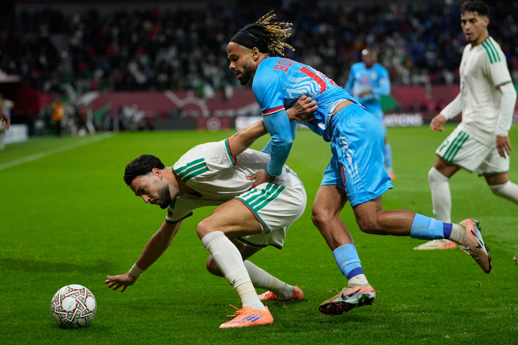 Algeria's Ramy Bensebaini, left, and DR Congo's Theo Bongonda fight for the ball during the Africa Cup of Nations round of 16 soccer match between Algeria and DR Congo in Rabat, Morocco, Tuesday, Jan. 6, 2026. (AP Photo/Mosa'ab Elshamy)