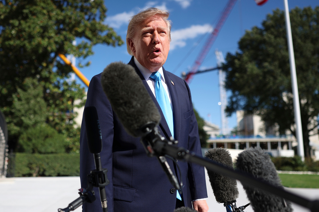 President Donald Trump speaks with reporters before walking to board Marine One on the South Lawn of the White House, Monday, Oct. 5, 2026, in Washington. (AP Photo/Tom Brenner)
