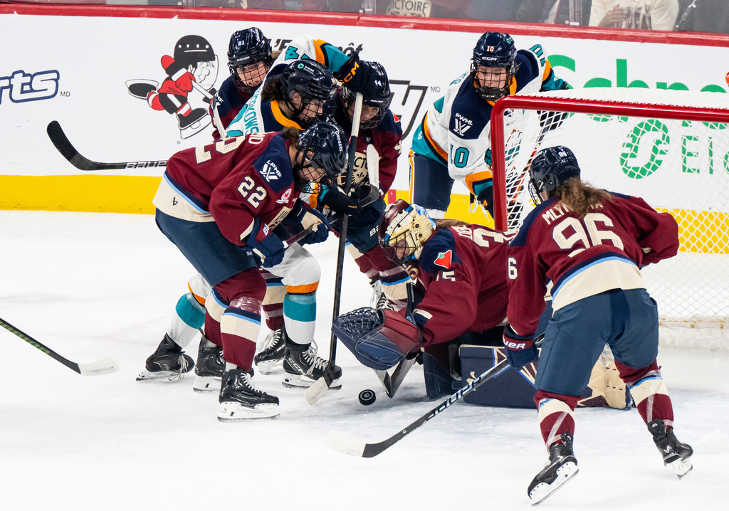 Montréal Victoire's goaltender Ann-Renée Desbiens (35) makes a save against New York Sirens' Anne Cherkowski (24) during first period PWHL hockey action in Tuesday, Nov. 25, 2025. (Christopher Katsarov/The Canadian Press via AP)
