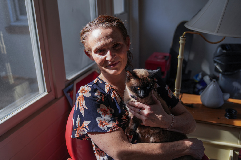 Jessica Thompson, 47, sits for a portrait at her Rockford, Ill., home on Saturday, March 21, 2026. (AP Photo/Erin Hooley)