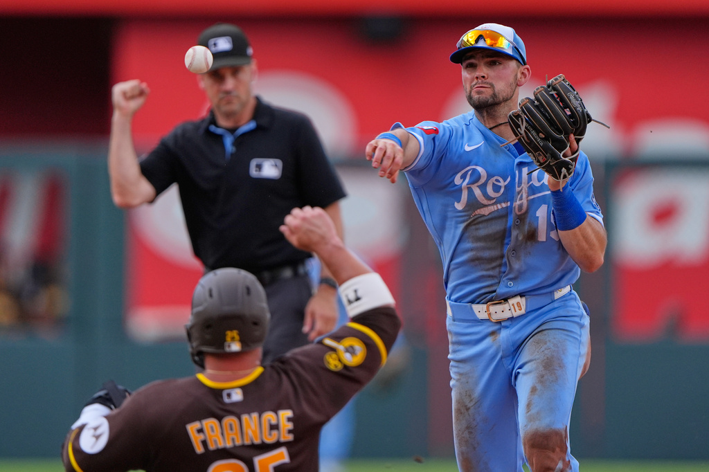 Kansas City Royals second baseman Michael Massey throws to first for the double play hit into by San Diego Padres' Miguel Andujar after forcing Ty France out at second to end the ninth inning of a baseball game Saturday, July 18, 2026, in Kansas City, Mo. (AP Photo/Charlie Riedel)