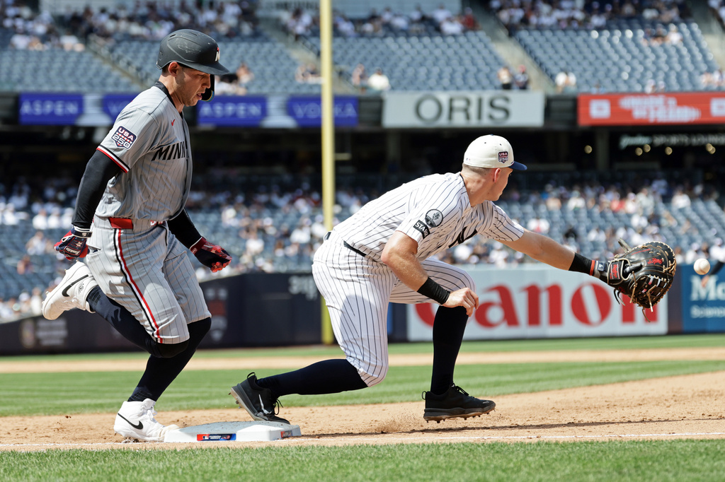 Minnesota Twins' Alex Jackson, left, is safe at first ahead of a throw to New York Yankees first baseman Ben Rice during the sixth inning of a baseball game Saturday, July 4, 2026, in New York. (AP Photo/Adam Hunger)