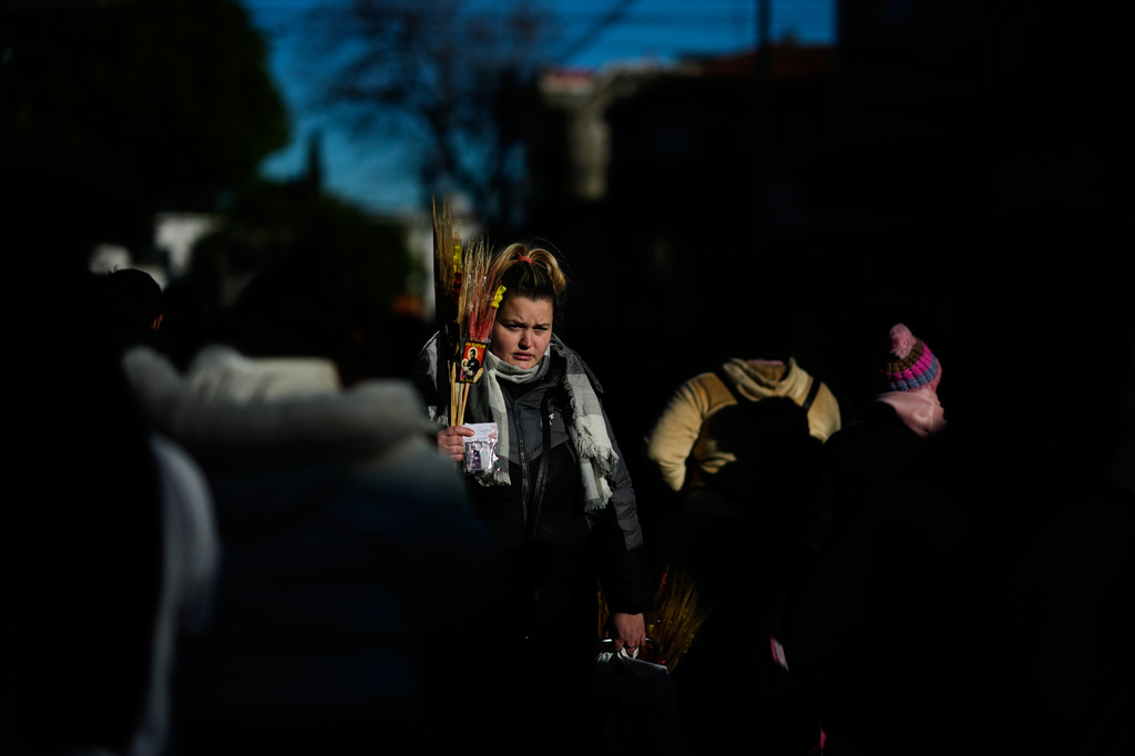 A religious souvenir vendor stands amid pilgrims waiting to enter the Church of San Cayetano during the annual pilgrimage honoring Saint Cajetan, the patron saint of work, in Buenos Aires, Argentina, Friday, Aug. 7, 2026. (AP Photo/Natacha Pisarenko)