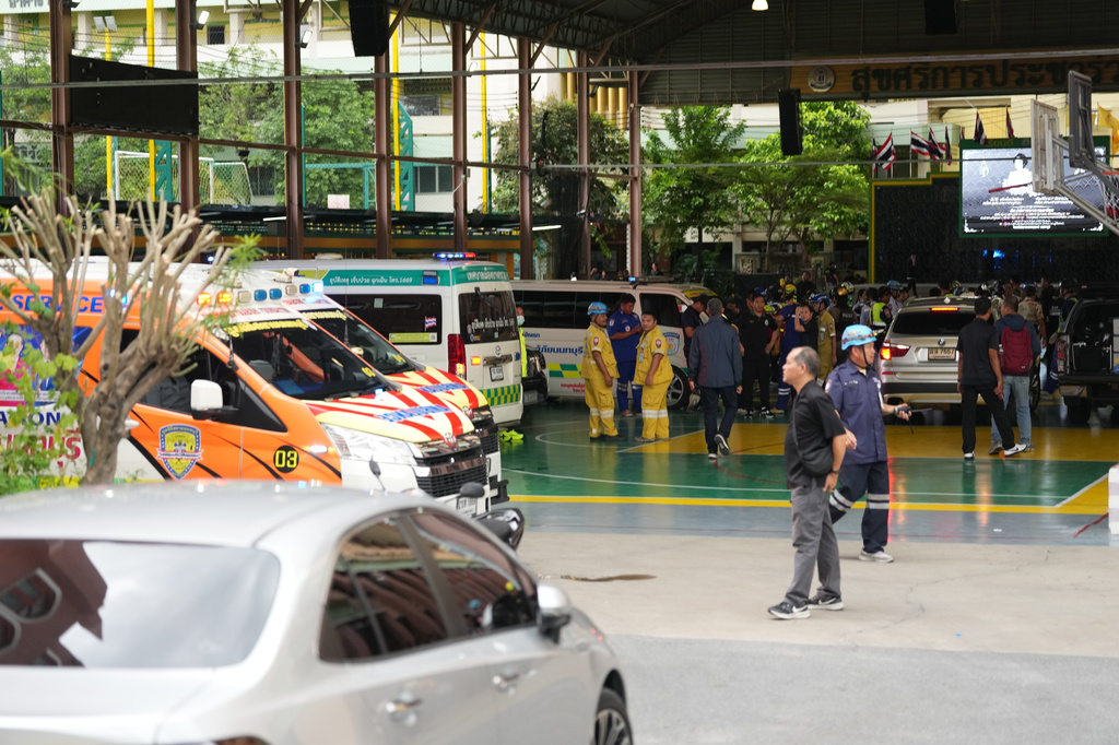 Ambulances stand in wait outside a school where deaths and injuries were reported after a shooting in Thailand's Nonthaburi province, Friday, Aug. 7, 2026. (AP Photo/Sakchai Lalit)