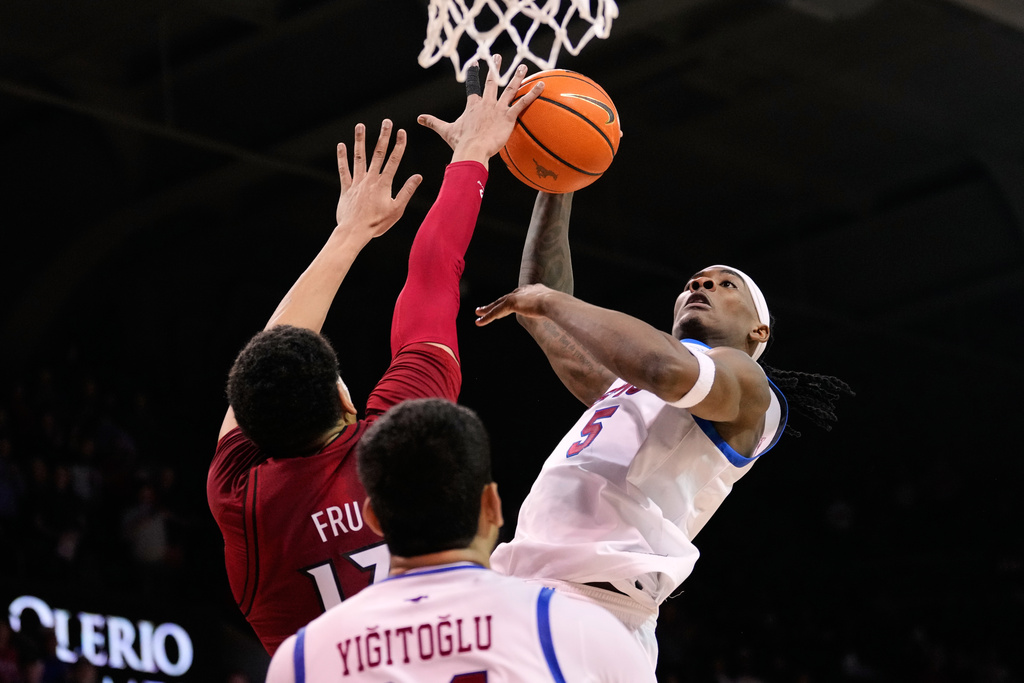 SMU guard Jaron Pierre Jr. (5) shoots over Louisville's Sananda Fru in the second half of an NCAA college basketball game in Dallas, Tuesday, Feb. 17, 2026. (AP Photo/Tony Gutierrez)