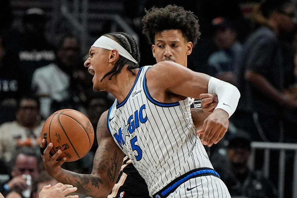 Orlando Magic forward Paolo Banchero (5) drives against Atlanta Hawks forward Jalen Johnson (1) during the first half of an NBA basketball game, Monday, March 16, 2026, in Atlanta. (AP Photo/Mike Stewart)