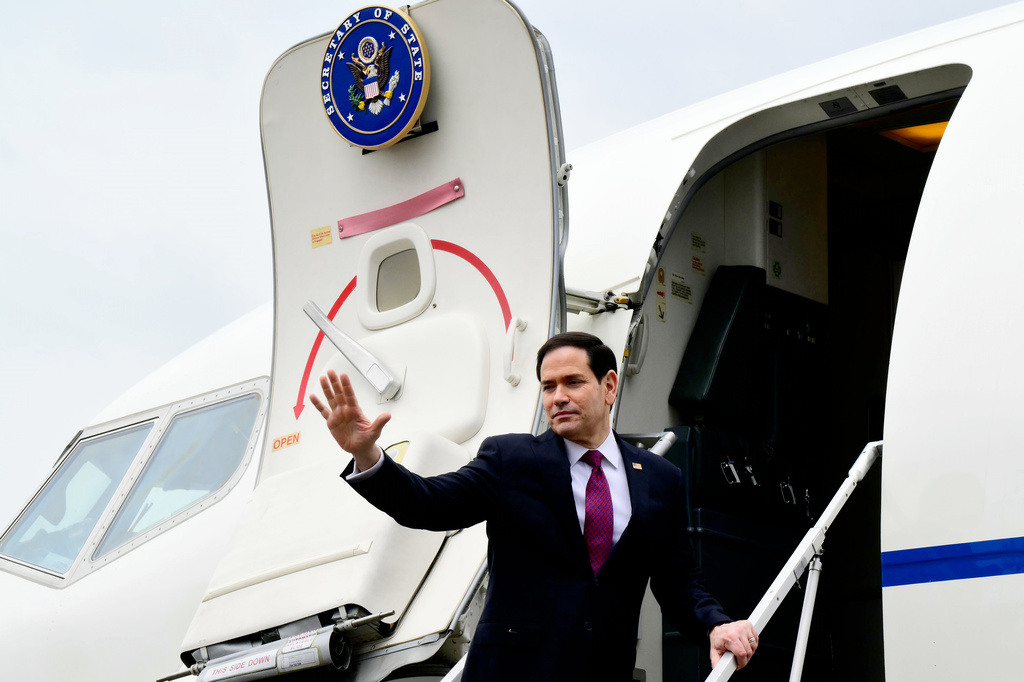 US Secretary of State Marco Rubio waves as he boards a US government aircraft after concluding his two-day visit to Italy and the Vatican, at Ciampino airport in Rome, Friday, May 8, 2026. (Stefano Rellandini/Pool Photo via AP)
