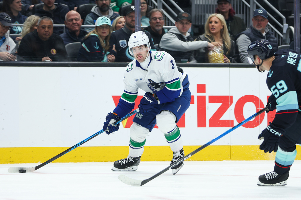 Vancouver Canucks right wing Conor Garland (8) looks to pass in the second period against the Seattle Kraken during an NHL hockey game Saturday, Feb. 28, 2026, in Seattle. (AP Photo/Kevin Ng)