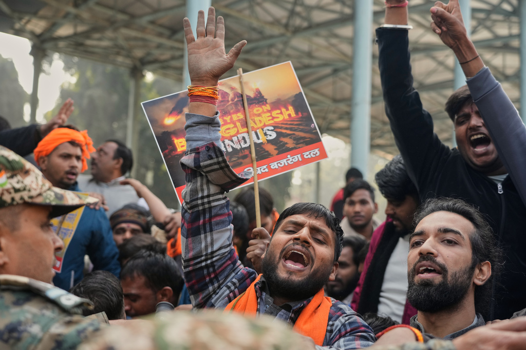Activists of Vishwa Hindu Parishad, a prominent right-wing Hindu nationalist organization, shout slogans during a protest near Bangladesh High Commission accusing Bangladeshi groups of wrongly targeting Indians, in New Delhi, India, Tuesday, Dec.23, 2025. (AP Photo/Manish Swarup)