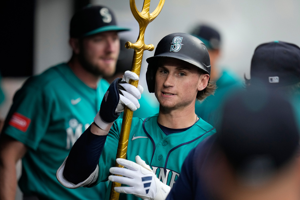 Seattle Mariners' Colt Emerson celebrates in the dugout after hitting a home run in the third inning of a baseball game against the Cleveland Guardians in Cleveland, Friday, June 26, 2026. (AP Photo/Sue Ogrocki)