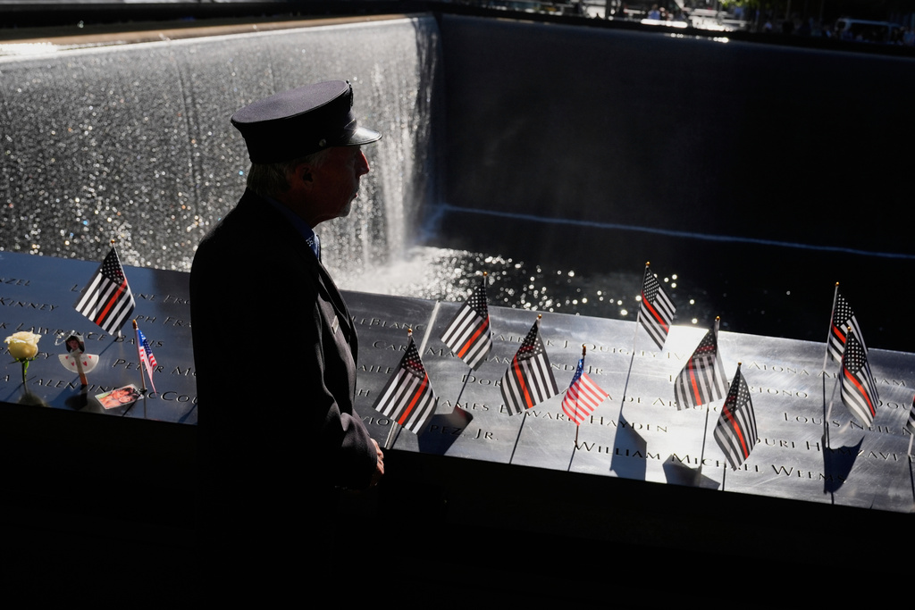 William Staudt, a firefighter that worked at Ground Zero on the day of the attacks, looks over a reflecting pool during a ceremony to mark the 24th anniversary of the 9/11 attacks, Thursday, Sept. 11, 2025, in New York. (AP Photo/Seth Wenig)