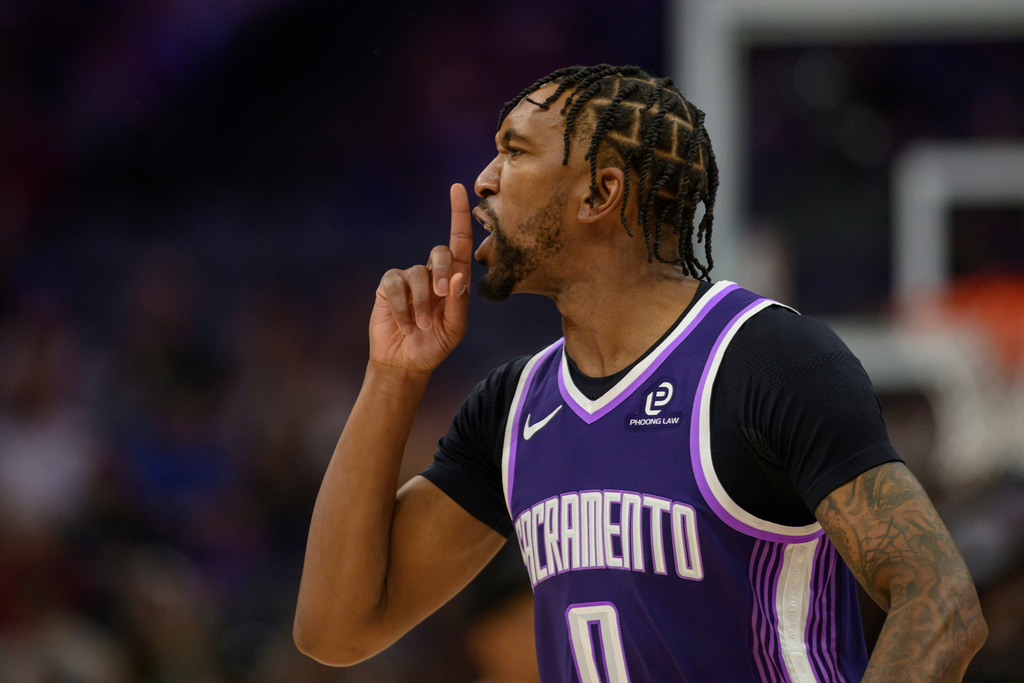 Sacramento Kings guard Malik Monk (0) taunts the Brooklyn Nets' bench after scoring a three point shot during the second half of an NBA basketball game in Sacramento, Calif., Sunday, March 22, 2026. (AP Photo/Randall Benton)