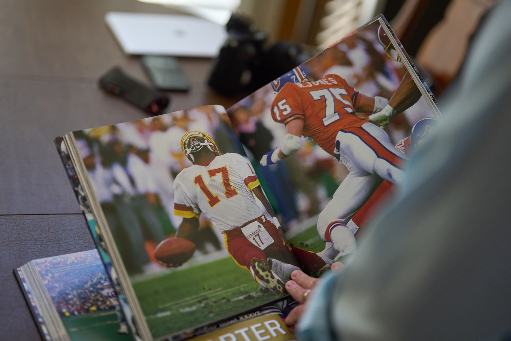 Photographer John Biever, who has shot every Super Bowl NFL football game, looks over images he has made at previous bowl games at his home Tuesday, Jan. 20, 2026, in San Diego. (AP Photo/Gregory Bull)