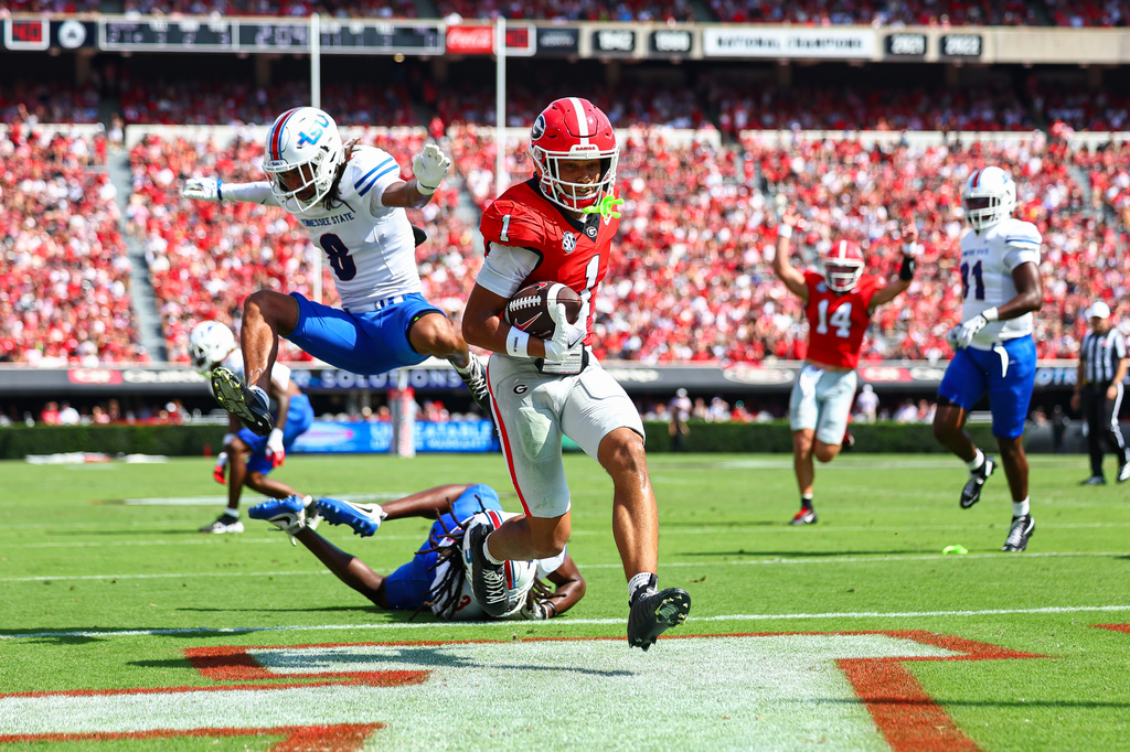 Georgia wide receiver Talyn Taylor (1) scores a touchdown against Tennessee State safety Brendan Hale (8) and defensive back Mikeece Jones (3) during the first half of an NCAA college football game, Saturday, Sept. 5, 2026, in Athens, Ga. (AP Photo/Colin Hubbard)