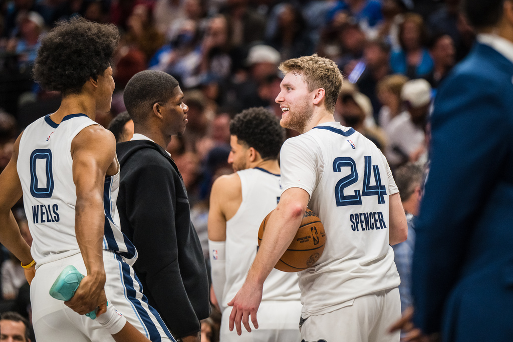 Memphis Grizzlies guard Cam Spencer (24) smiles at Grizzlies forward Jaylen Wells (0) while in a timeout during an NBA basketball game against the Dallas Mavericks, Friday, Feb. 27, 2026, in Dallas. (AP Photo/Jessica Tobias)