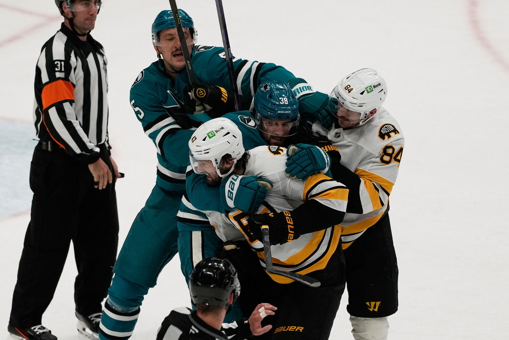San Jose Sharks defenseman Vincent Desharnais, second from top left, and Boston Bruins left wing Tanner Jeannot (84) try to separate Sharks defenseman Mario Ferraro, middle, and Bruins center Mark Kastelic (47) after an NHL hockey game in San Jose, Calif., Sunday, Nov. 23, 2025. (AP Photo/Jeff Chiu)