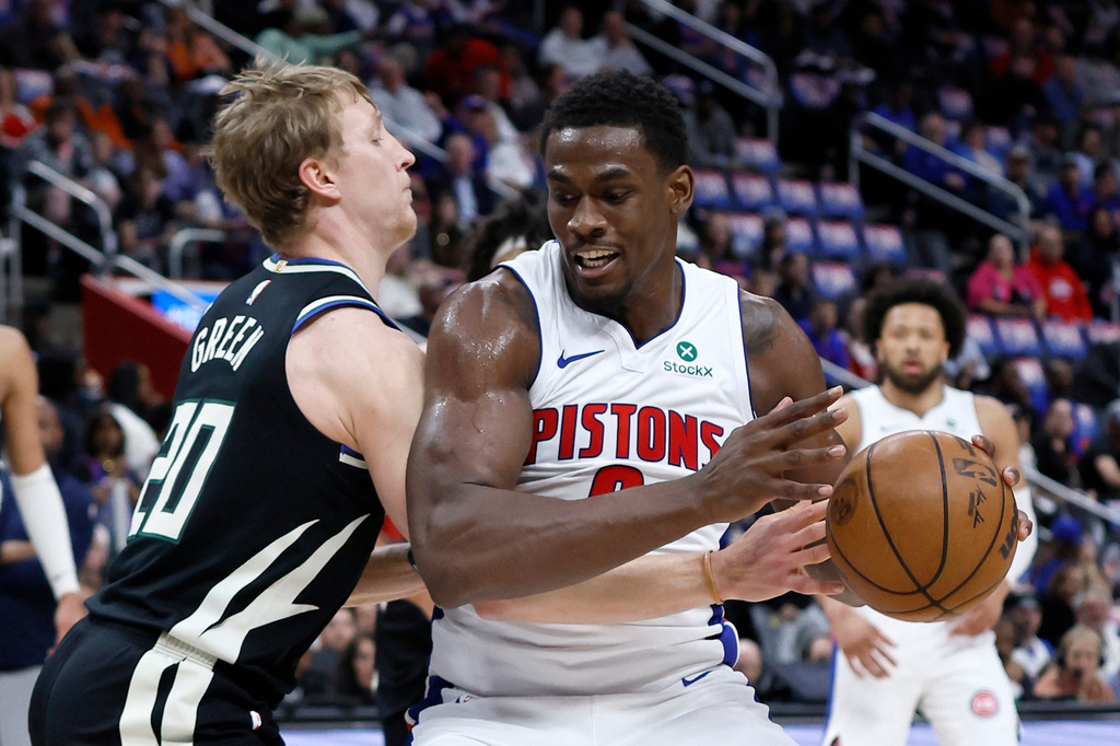 Detroit Pistons center Jalen Duren (0) drives against Milwaukee Bucks guard AJ Green (20) during the first half of an NBA basketball game Wednesday, April 8, 2026, in Detroit. (AP Photo/Duane Burleson)