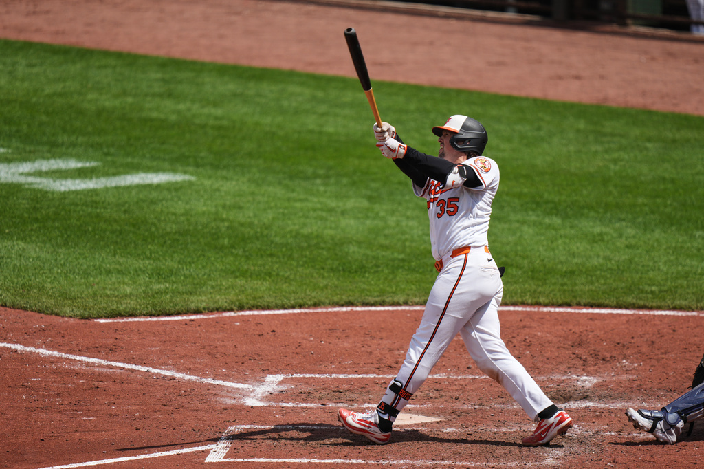 Baltimore Orioles' Adley Rutschman (35) hits a grand slam during the fifth inning in the first baseball game of a doubleheader against the Houston Astros, Thursday, April 30, 2026, in Baltimore. (AP Photo/Stephanie Scarbrough)