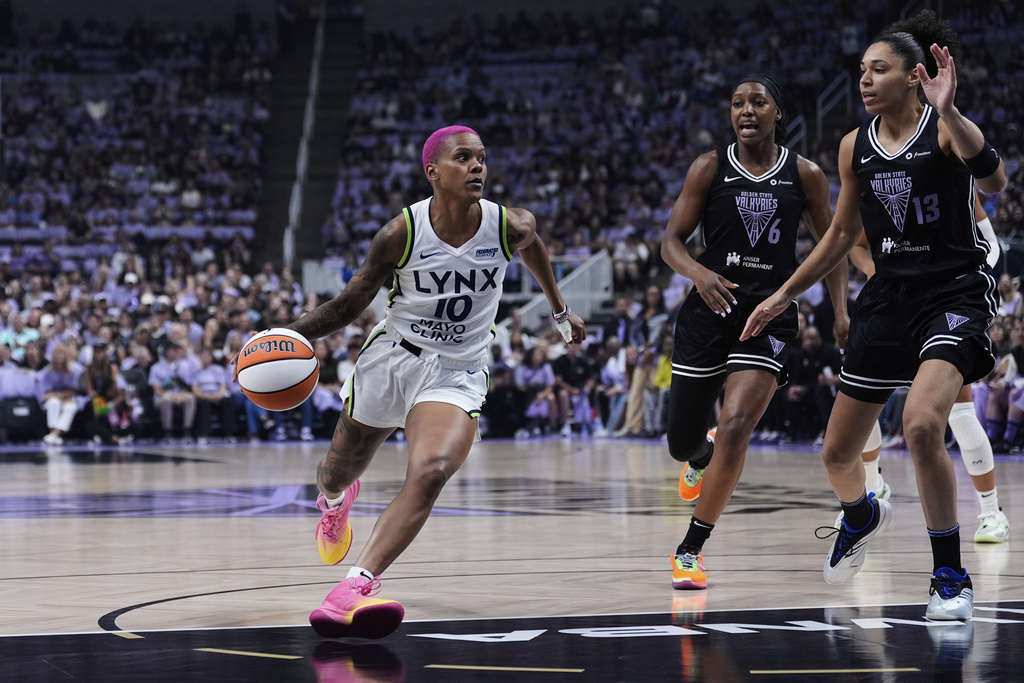 Minnesota Lynx guard Courtney Williams (10) moves the ball next to Golden State Valkyries forward Janelle Salaün (13) during the first half of Game 2 in the first round of the WNBA basketball playoffs Wednesday, Sept. 17, 2025, in San Jose, Calif. (AP Photo/Godofredo A. Vásquez)