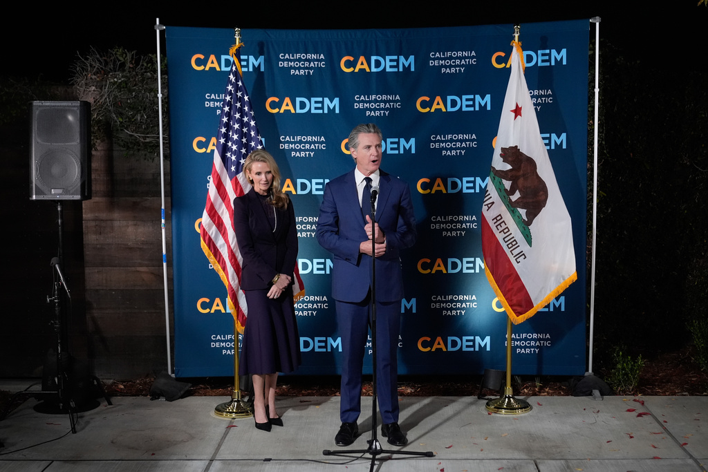 California Gov. Gavin Newsom stands first partner Jennifer Siebel Newsom as he speaks during an election night press conference at a California Democratic Party office Tuesday, Nov. 4, 2025, in Sacramento, Calif. (AP Photo/Godofredo A. Vásquez)