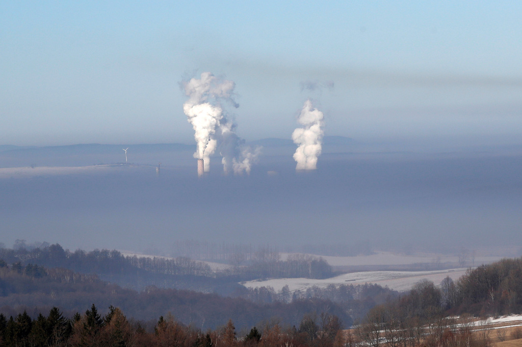 FILE - Smoke rises from chimneys of the coal-fired power plant in Bogatynia, Poland. The picture was taken from a hill near the town of Frydlant, Czech Republic, Tuesday, Feb. 14, 2017. (AP Photo/Petr David Josek, File)