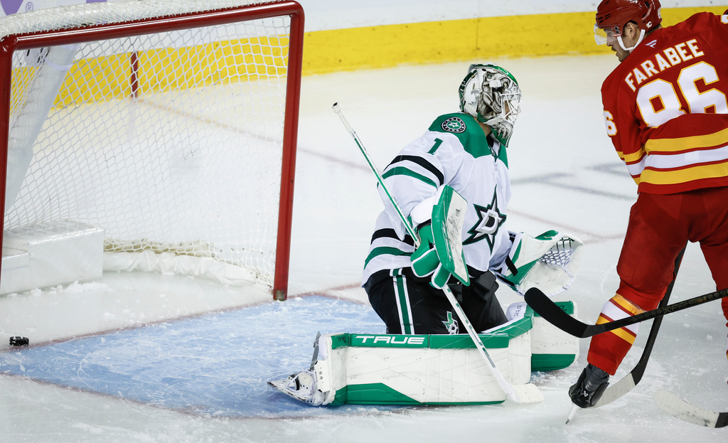 Dallas Stars goalie Casey DeSmith is scored on by Calgary Flames' Joel Farabee during the third period of an NHL hockey game in Calgary, Alberta, Saturday, Nov. 22, 2025. (Jeff McIntosh/The Canadian Press via AP)