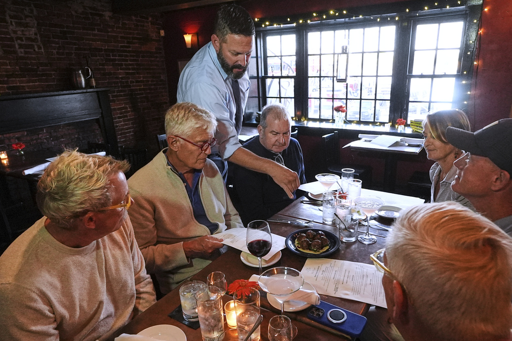 Jon Plaza explains the locally foraged ingredients of the Lebanese lamb meatball appetizer to a group dining at the Black Trumpet restaurant, Tuesday, Sept. 16, 2025, in Portsmouth, N.H. (AP Photo/Charles Krupa)