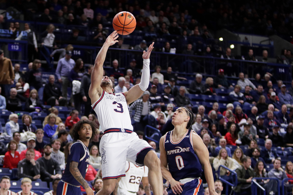 Gonzaga guard Braeden Smith (3) shoots next to Pepperdine guard Styles Phipps (0) during the second half of an NCAA college basketball game, Wednesday, Jan. 21, 2026, in Spokane, Wash. (AP Photo/Young Kwak)