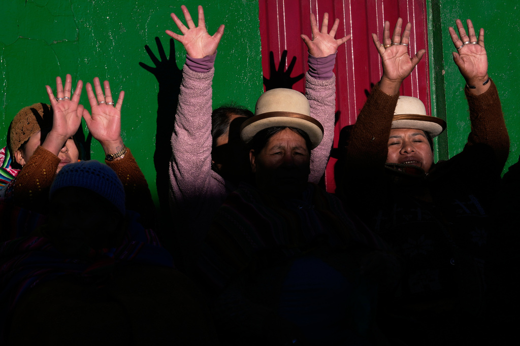 FILE - Aymara women raise their hands to receive the first rays of sunlight during celebrations of the Andean New Year, which marks the Southern Hemisphere's winter solstice, in El Alto, Bolivia, June 21, 2026. (AP Photo/Juan Karita, File)