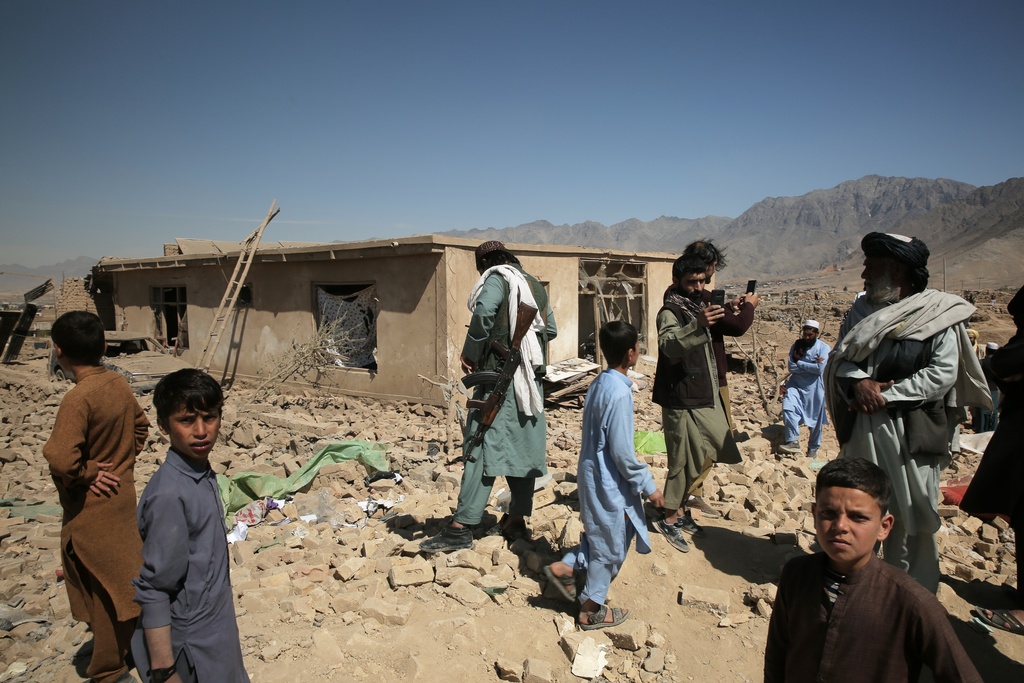 Residents inspect the site of a strike in Kabul, Afghanistan, Friday, March 13, 2026. (AP Photo/Barackatullah Popal)