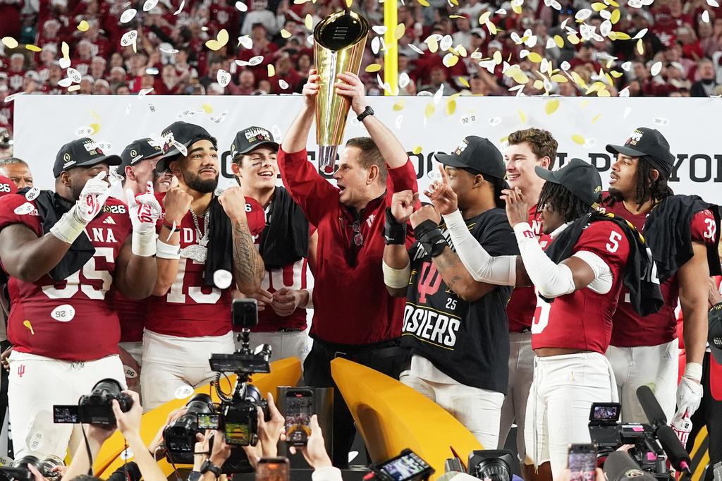 FILE - Indiana head coach Curt Cignetti holds the trophy after their win against Miami in the College Football Playoff national championship game in Miami Gardens, Fla., Jan. 19, 2026. (AP Photo/Lynne Sladky, File)