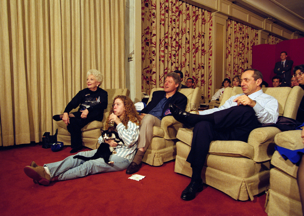 FILE - President Bill Clinton, flanked by Governors Ann Richards of Texas and Mario Cuomo of New York, watches the Dallas Cowboys and Buffalo Bills play at the Super Bowl, with his daughter Chelsea and their cat Socks at the White House, Jan. 31, 1993, in the family theater in the east wing. (AP Photo/Wilfredo Lee, File)
