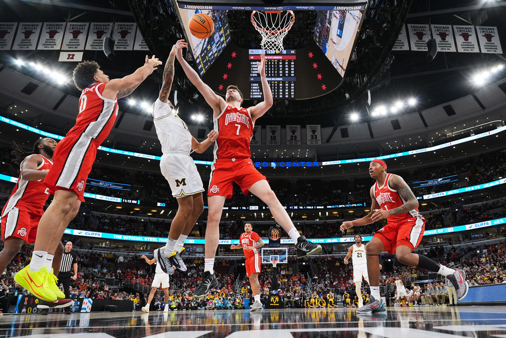 Michigan guard Roddy Gayle Jr., second from left, battles for a rebound with Ohio State guard John Mobley Jr., left, and center Ivan Njegovan (7) during the first half of an NCAA college basketball game in the quarterfinals of the Big 10 Conference tournament, Friday, March 13, 2026, in Chicago. (AP Photo/Nam Y. Huh)