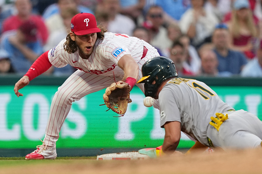 Athletics' Brett Harris beats the throw to Philadelphia Phillies third baseman Alec Bohm during the third inning of a baseball game, Tuesday, May 5, 2026, in Philadelphia. (AP Photo/Matt Rourke)