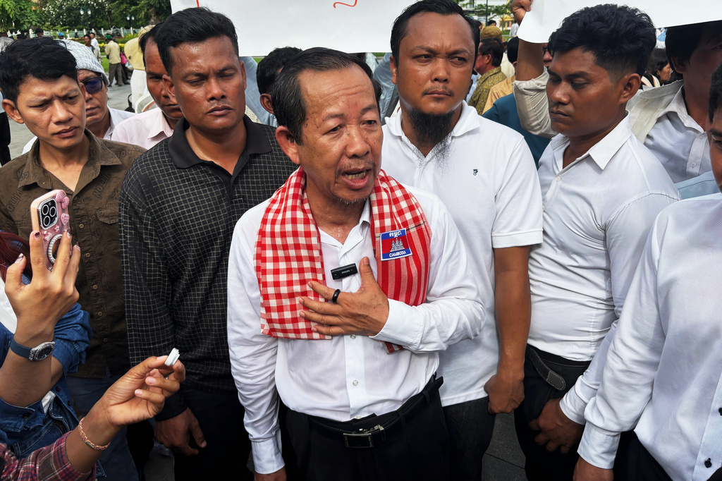 Rong Chhun, a top adviser to the Nation Power Party and a prominent opposition politician, stands with supporters outside Cambodia's Supreme Court in Phnom Penh, Friday, June 19, 2026. (AP Photo/Sopheng Cheang)
