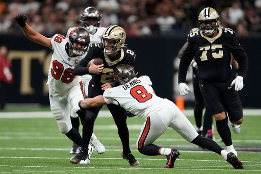Tampa Bay Buccaneers linebacker SirVocea Dennis (8) and linebacker Anthony Nelson (98) force New Orleans Saints quarterback Spencer Rattler (2) into a turn over during the first half of an NFL football game Sunday, Oct. 26, 2025, in New Orleans. (AP Photo/Gerald Herbert) Tampa Bay Buccaneers linebacker SirVocea Dennis (8) and linebacker Anthony Nelson (98) force New Orleans Saints quarterback Spencer Rattler (2) into a turn over during the first half of an NFL football game Sunday, Oct. 26, 2025, in New Orleans. (AP Photo/Gerald Herbert)