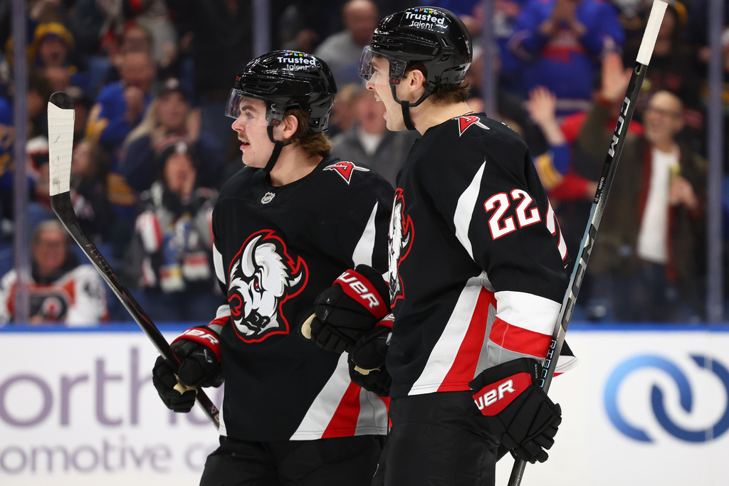 Buffalo Sabres right wing Jack Quinn (22) celebrates his goal with left wing Zach Benson, left, during the first period of an NHL hockey game against the Philadelphia Flyers Thursday, Dec. 18, 2025, in Buffalo, N.Y. (AP Photo/Jeffrey T. Barnes)