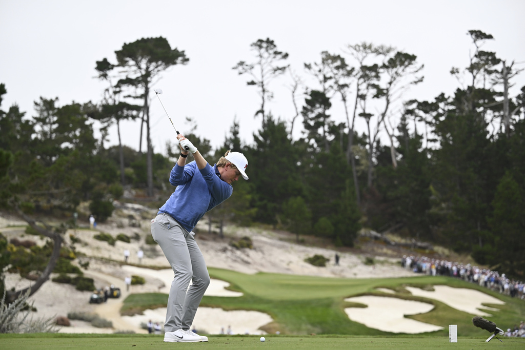 The Great Britain and Ireland team's Luke Poulter hits from the seventh tee during Walker Cup golf matches against the USA team at Cypress Point Club on Saturday, Sept. 6, 2025, in Pebble Beach, Calif. (AP Photo/Thien-An Truong)